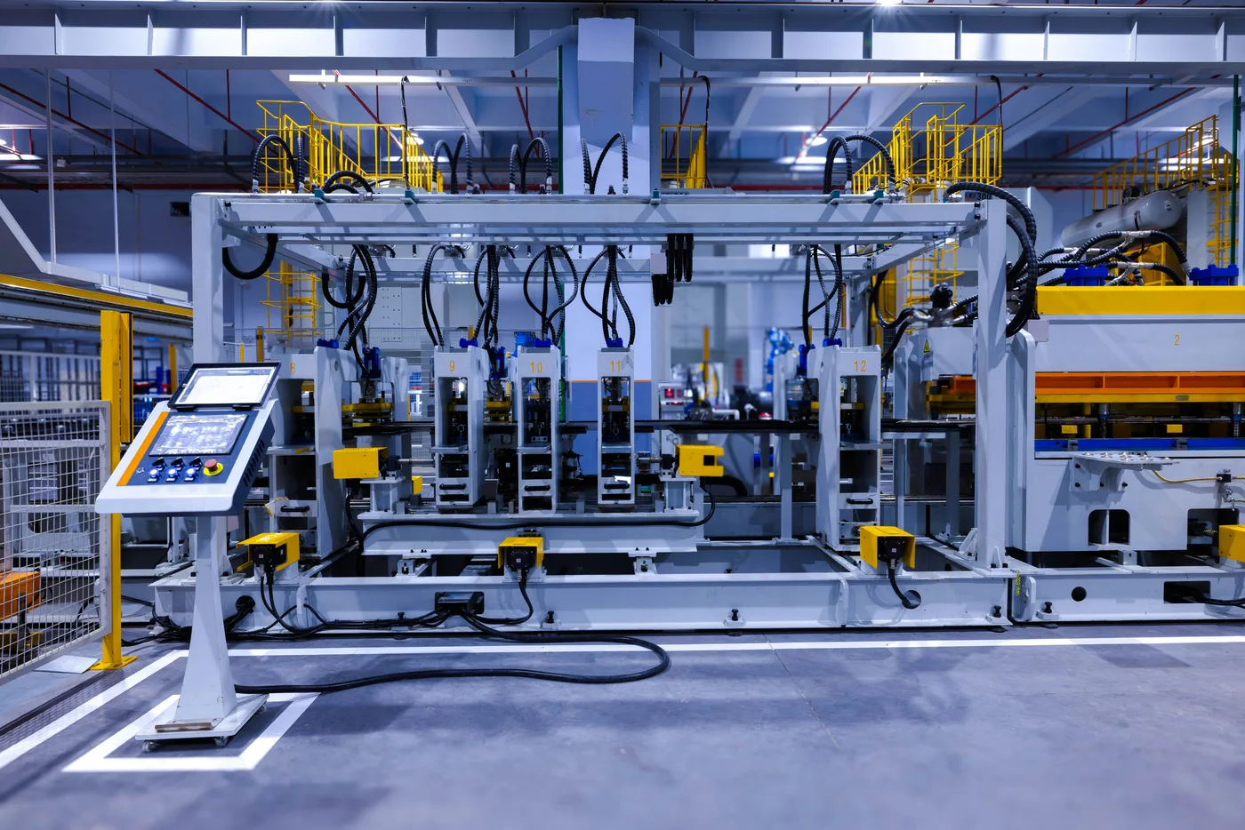 A row of automated press stations in a production hall